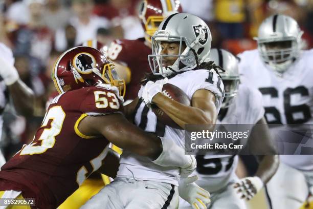 Outside linebacker Ryan Anderson tackles wide receiver Seth Roberts of the Oakland Raiders at FedExField on September 24, 2017 in Landover, Maryland.