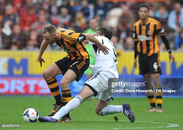 Hull City's David Meyler is fouled by Swansea City's Michu during the Barclays Premier League match at the KC Stadium, Hull.