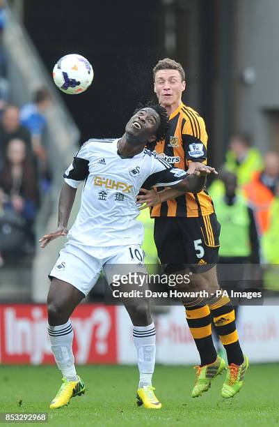 Swansea City's Wilfried Bony and Hull City's James Chester battle for the ball during the Barclays Premier League match at the KC Stadium, Hull.