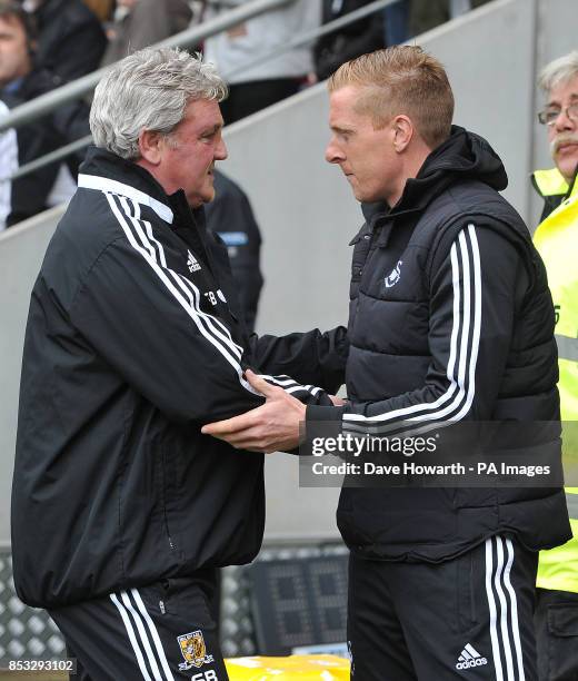 Hull City's Manager Steve Bruce and Swansea City's Manager Garry Monk shake hands before the game during the Barclays Premier League match at the KC...