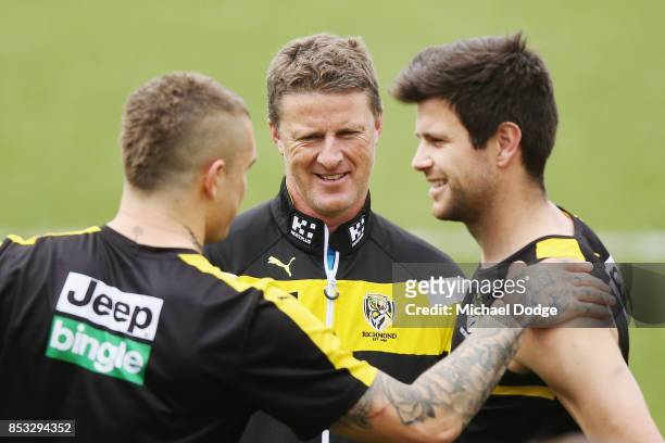 Tigers head coach Damien Hardwick talks with Dustin Martin and Trent Cotchin of the Tigers during a Richmond Tigers AFL media oportunity at Punt Road...