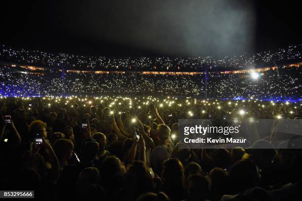 Fans hold up their cell phones with the lights on at "A Concert for Charlottesville," at University of Virginia's Scott Stadium on September 24, 2017...