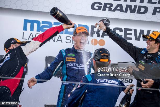 Renger van der Zande of the Netherlands is doused with champagne in victory lane after winning the IMSA WeatherTech Sportscar Championship race at...
