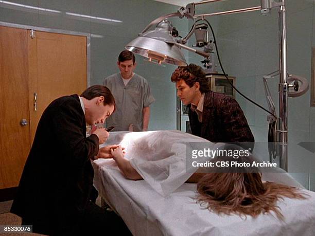 Watched by Canadian actor Michael Ontkean , American actor Kyle MacLachlan examines the hand of German-born American actress Sheryl Lee in a scene...