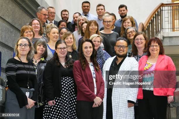 Labour leader Jacinda Ardern poses with staff members prior to an announcement for Labour's new provisional caucus members at Parliament on September...