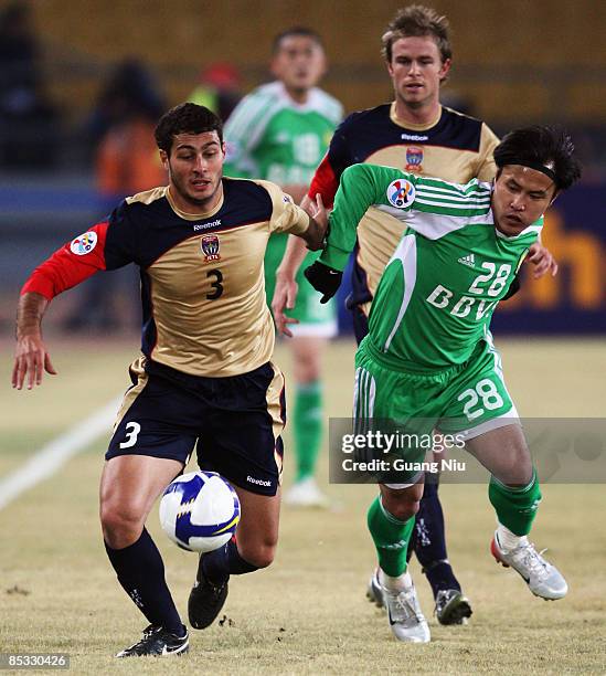 Adam Leonard D'Apuzzo of Newcastle Jets and Guo Hui of Beijing Guoan fight for a ball during the AFC Champions League Group E match between Beijing...