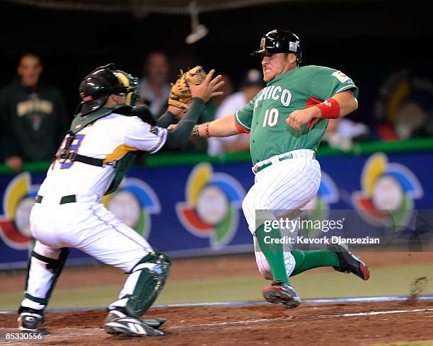 Karim Garcia of Mexico is tagged out at home plate by Kyle Botha of South Africa during the eighth inning of the 2009 World Baseball Classic Pool B...