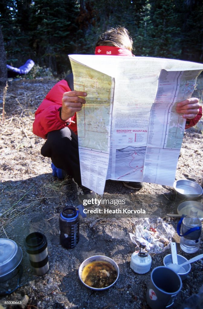 A backpacker checks his map.