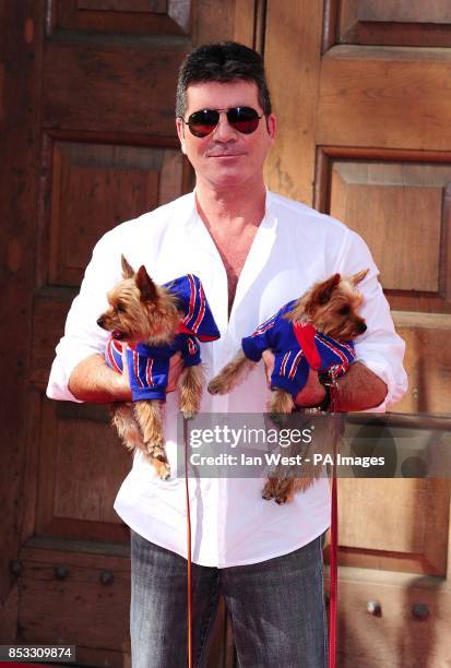 Simon Cowell with his dogs Squiddly and Diddly attending a press launch for Britain's Got Talent at LSO St Luke's in London.