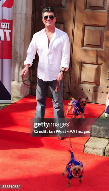 Simon Cowell with his dogs Squiddly and Diddly attending a press launch for Britain's Got Talent at LSO St Luke's in London.