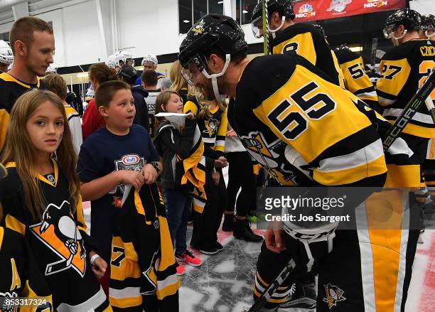 Chris Summers of the Pittsburgh Penguins gives a young fan an autographed Hockeyville jersey after the game against the St. Louis Blues at UPMC...