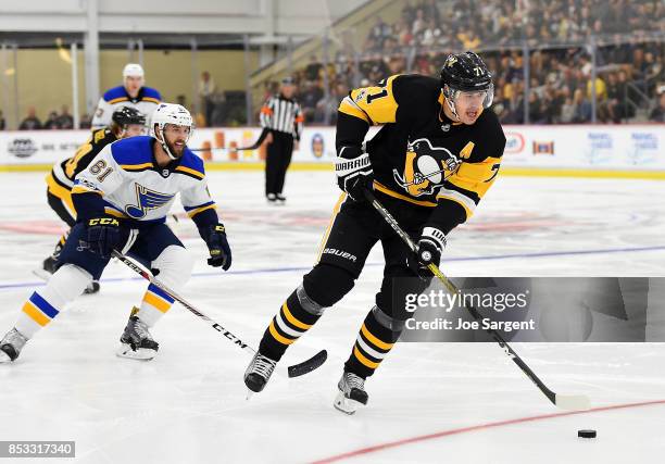 Evgeni Malkin of the Pittsburgh Penguins moves the puck in front of Wade Megan of the St. Louis Blues at UPMC Lemieux Sports Complex on September 24,...