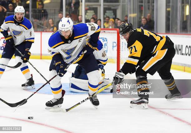 Alex Pietrangelo of the St. Louis Blues battles for the puck against Evgeni Malkin of the Pittsburgh Penguins at UPMC Lemieux Sports Complex on...