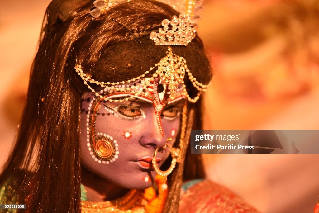 An Indian artist dressed as Hindu Goddess Kali perform...