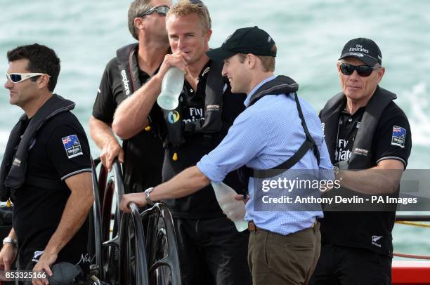 The Duke of Cambridge steers a yacht as the Duke and Duchess of Cambridge race against each other on two Emirates Team New Zealand Americas Cup...