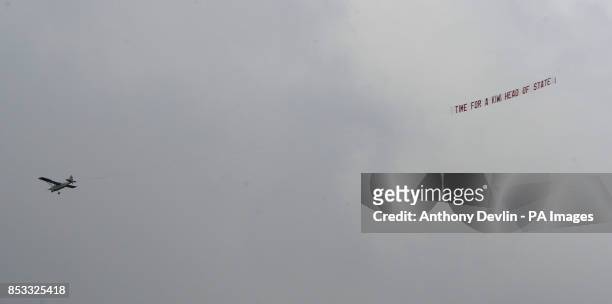 Plane tows a banner reading time for a Kiwi head of state as the Duke and Duchess of Cambridge race against each other on two Emirates Team New...