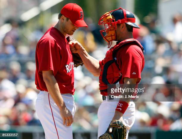 Catcher Jason Varitek and pitcher Jonathan Papelbon of the Boston Red Sox talk strategy against the Baltimore Orioles during a Grapefruit League...