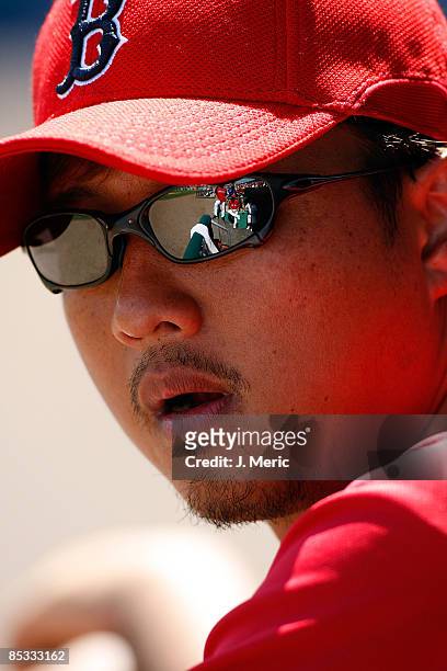 Pitcher Hideki Okajima of the Boston Red Sox watches his team from the dugout against the Baltimore Orioles during a Grapefruit League Spring...