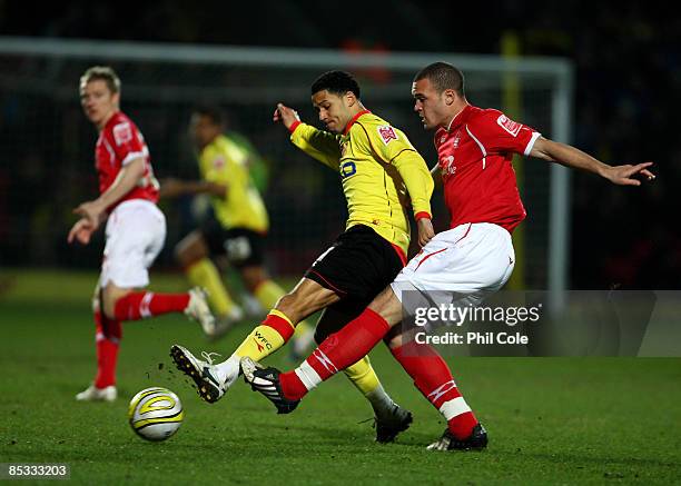 Jobi McAnuff of Watford battles for the ball with Joel Lynch of Nottingham Forest during the Coca Cola Championship match between Watford and...