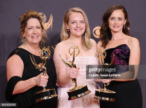 Actors Ann Dowd, Elisabeth Moss, and Alexis Bledel, winners of the award for Outstanding Drama Series for 'The Handmaid's Tale,' pose in the press...