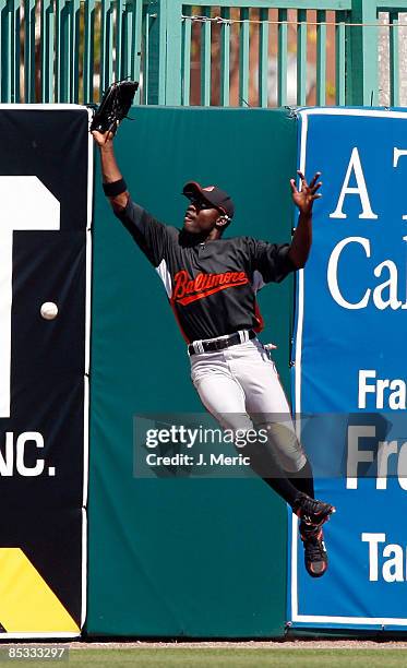 Outfielder Felix Pie of the Baltimore Orioles misses a catch on a fly ball against the Boston Red Sox during a Grapefruit League Spring Training Game...