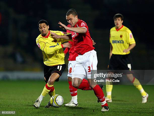 Jobi McAnuff of Watford battles for the ball with Joel Lynch of Nottingham Forest during the Coca Cola Championship match between Watford and...