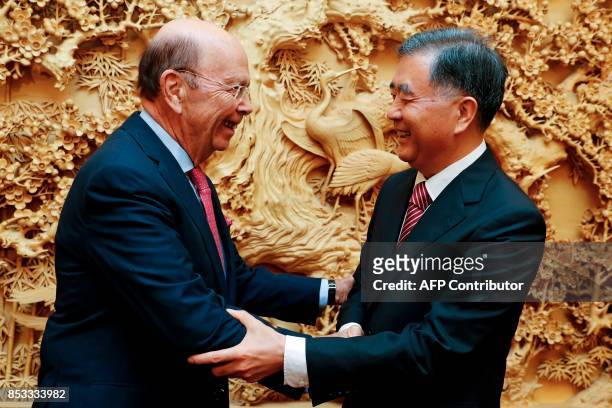 Commerce Secretary Wilbur Ross shakes hands with Chinese Vice Premier Wang Yang before a bilateral meeting at the Zhongnanhai Leadership Compound in...