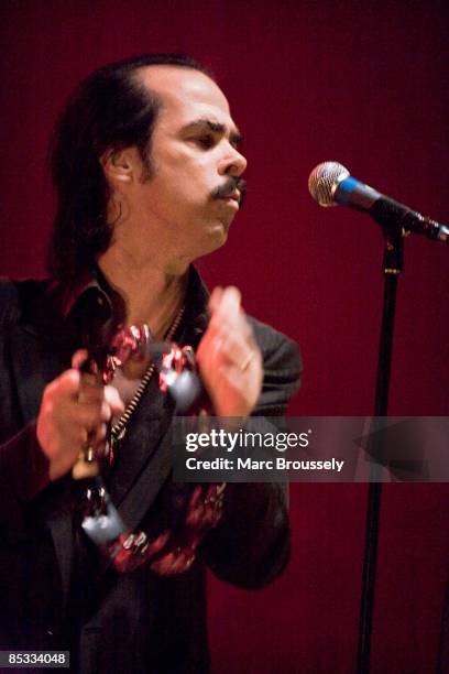 Photo of Nick CAVE and Nick CAVE & THE BAD SEEDS, Nick Cave performing on stage, tambourine