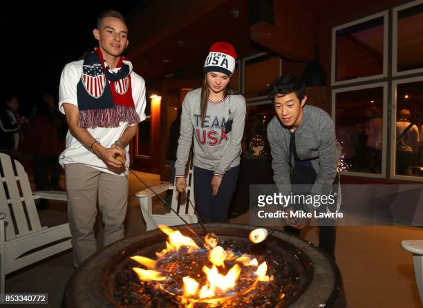 Figure skaters Adam Rippon, Mariah Bell and Nathan Chen make smores during the Team USA Media Summit opening reception at the Red Pine Lodge on...