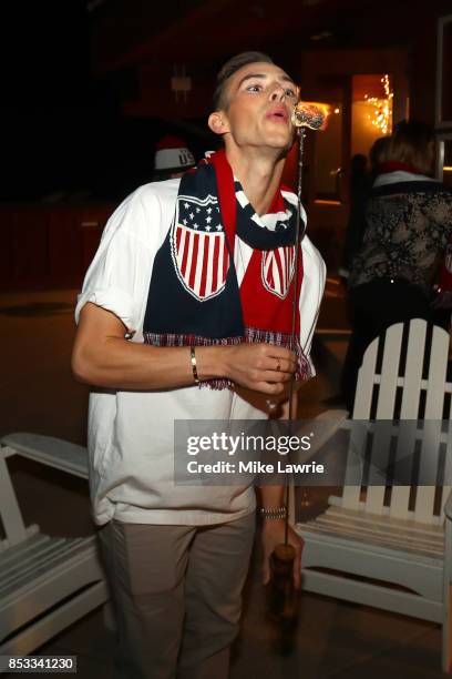 Figure skater Adam Rippon makes smores during the Team USA Media Summit opening reception at the Red Pine Lodge on September 24, 2017 in Park City,...