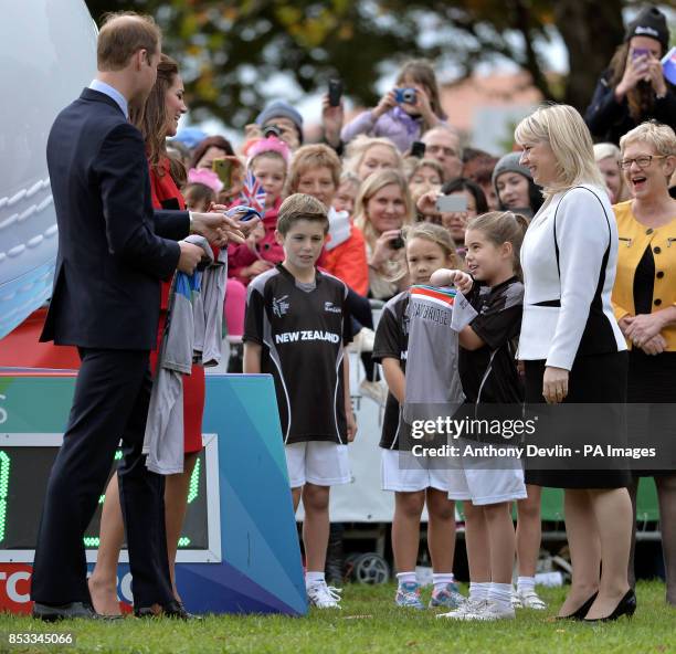 The Duke and Duchess of Cambridge receive a baby cricket shirt with the name Cambridge on the back as they watch a 2015 Cricket World Cup event in...