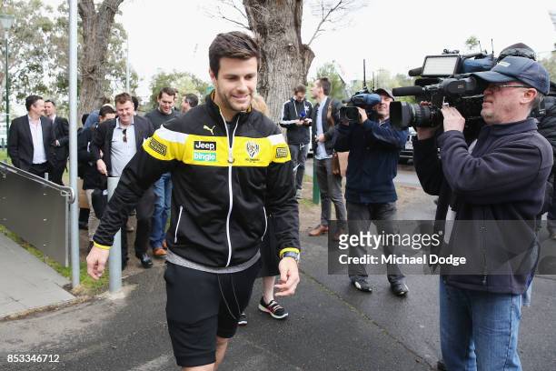 Trent Cotchin of the Tigers walks off from speaking to the media after he was cleared of any penalty for his bump on Dylan Shiel of the Giants on the...