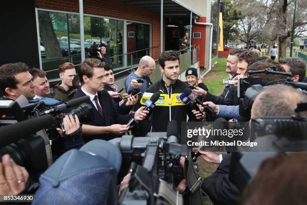 Trent Cotchin of the Tigers speaks to the media after he was cleared of any penalty for his bump on Dylan Shiel of the Giants on the weekend during a...