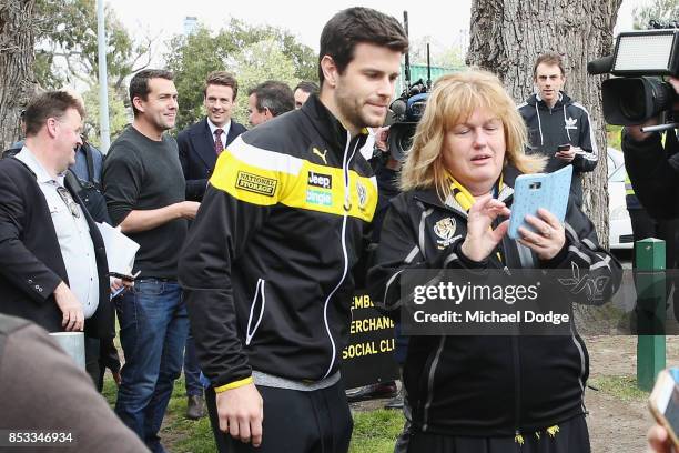 Trent Cotchin of the Tigers poses for a fan after speaking to the media after he was cleared of any penalty for his bump on Dylan Shiel of the Giants...
