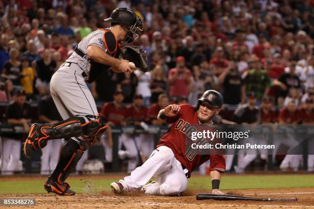Chris Herrmann of the Arizona Diamondbacks is forced out at home plate by catcher J.T. Realmuto of the Miami Marlins during the ninth inning of the...