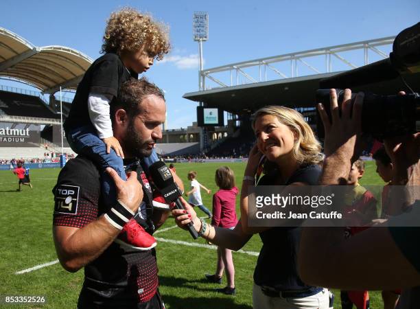 Frederic Michalak of LOU is interviewed by Astrid Bard of Canal Plus following the Top 14 match between Lyon OU and Castres Olympique at Matmut...