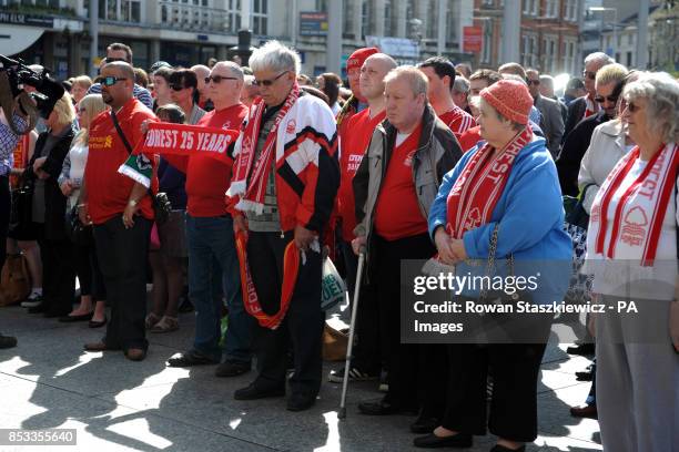 Football fans pays their respect to the victims of the Hillsborough disaster in Market Square, Nottingham.