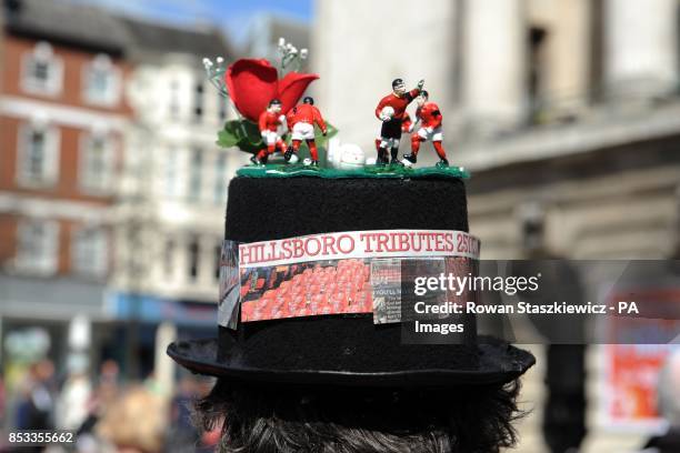 Football fan pays his respect to the victims of the Hillsborough disaster in Market Square, Nottingham.