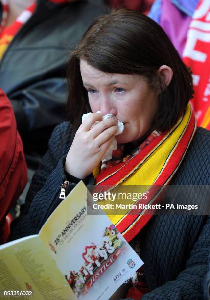 Liverpool fan wipes away tears during the Hillsborough 25th Anniversary Memorial Service at Anfield Stadium, Liverpool.