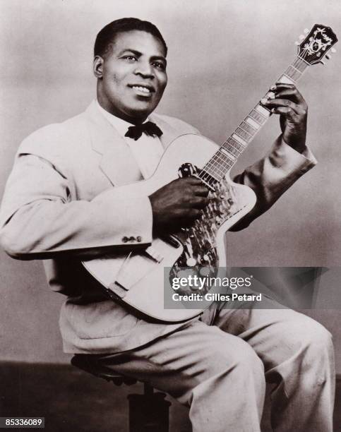 Photo of Howlin' WOLF; Posed studio portrait of Howlin' Wolf, with guitar