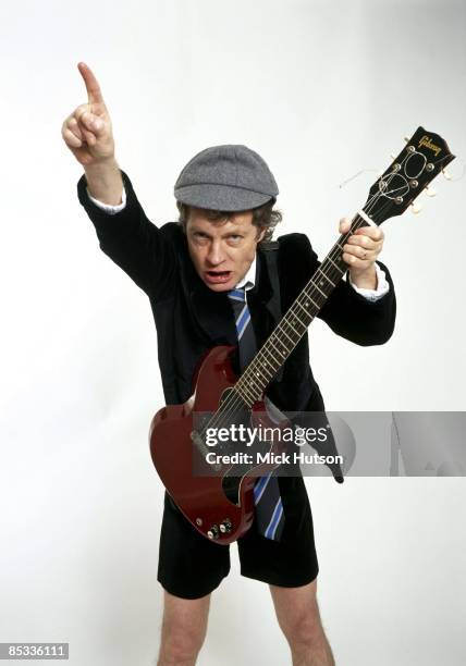 Photo of Angus YOUNG and AC/DC; Posed studio portrait of Angus Young, Gibson SG Junior guitar