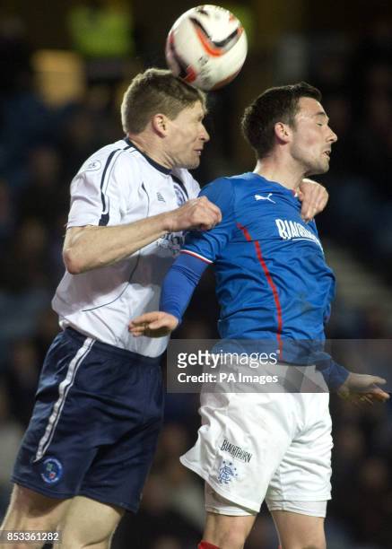 Rangers' Nicky Clark and Forfar Athletic's Darren Dods jump for the ball during the Scottish League One match at Ibrox Stadium, Glasgow.