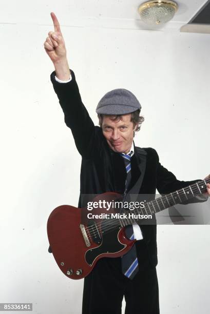 Photo of Angus YOUNG and AC/DC; Posed studio portrait of Angus Young, Gibson SG Junior guitar