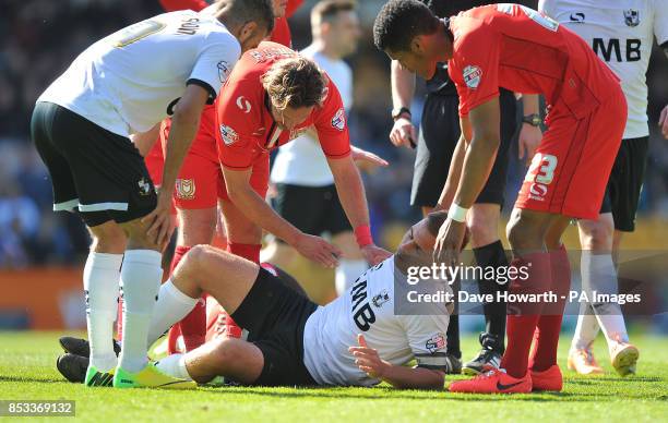 Port Vale's Tom Pope lies on the ground with a suspected leg injury during the Sky Bet League One match at Vale Park, Stoke On Trent.