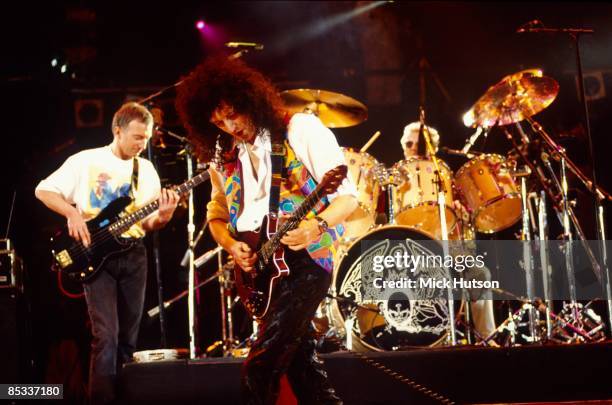 Photo of Roger TAYLOR and QUEEN and John DEACON and Brian MAY, L-R John Deacon, Brian May and Roger Taylor performing on stage at the Freddie Mercury...