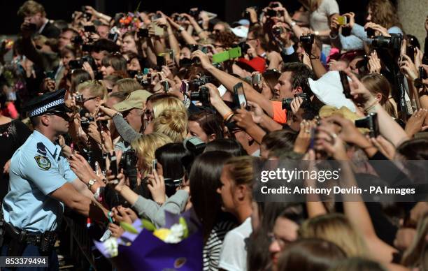 Well wishers look-on as the Duke and Duchess of Cambridge leave the Easter Sunday Church Service at St Andrew's Cathedral, Sydney during the...