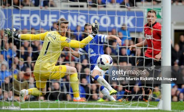 Everton's Kevin Mirallas scores their second goal past Manchester United goalkeeper David De Gea during the Barclays Premier League match at Goodison...