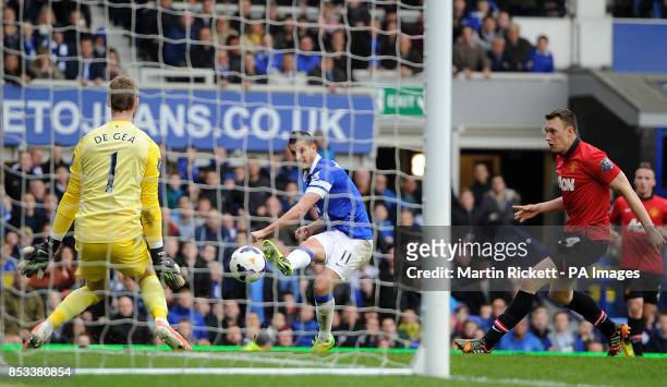 Everton's Kevin Mirallas scores their second goal past Manchester United goalkeeper David De Gea during the Barclays Premier League match at Goodison...