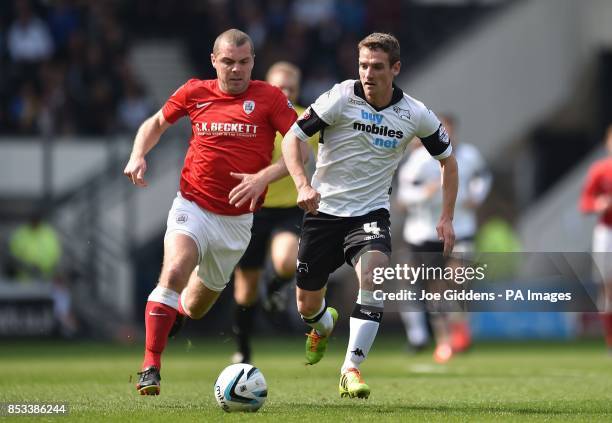 Derby County's Craig Bryson gets away from Barnsley's Stephen Dawson during the Sky Bet Championship match at the iPRO Stadium, Derby.