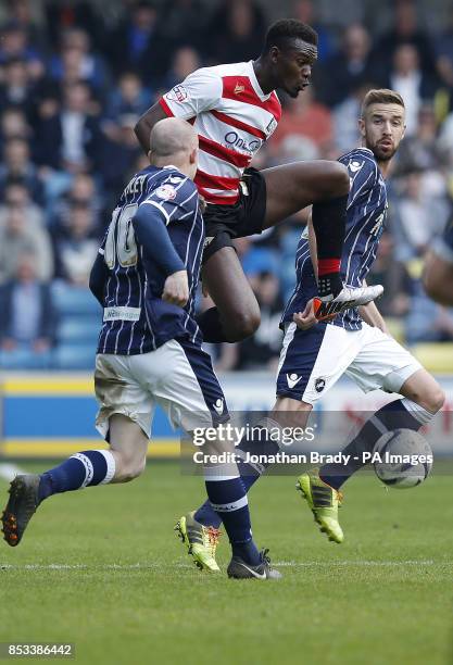 Doncaster's Theo Robinson gets between Millwall's Nicky Bailey and Mark Beevers during the Sky Bet Championship match at The New Den, London.